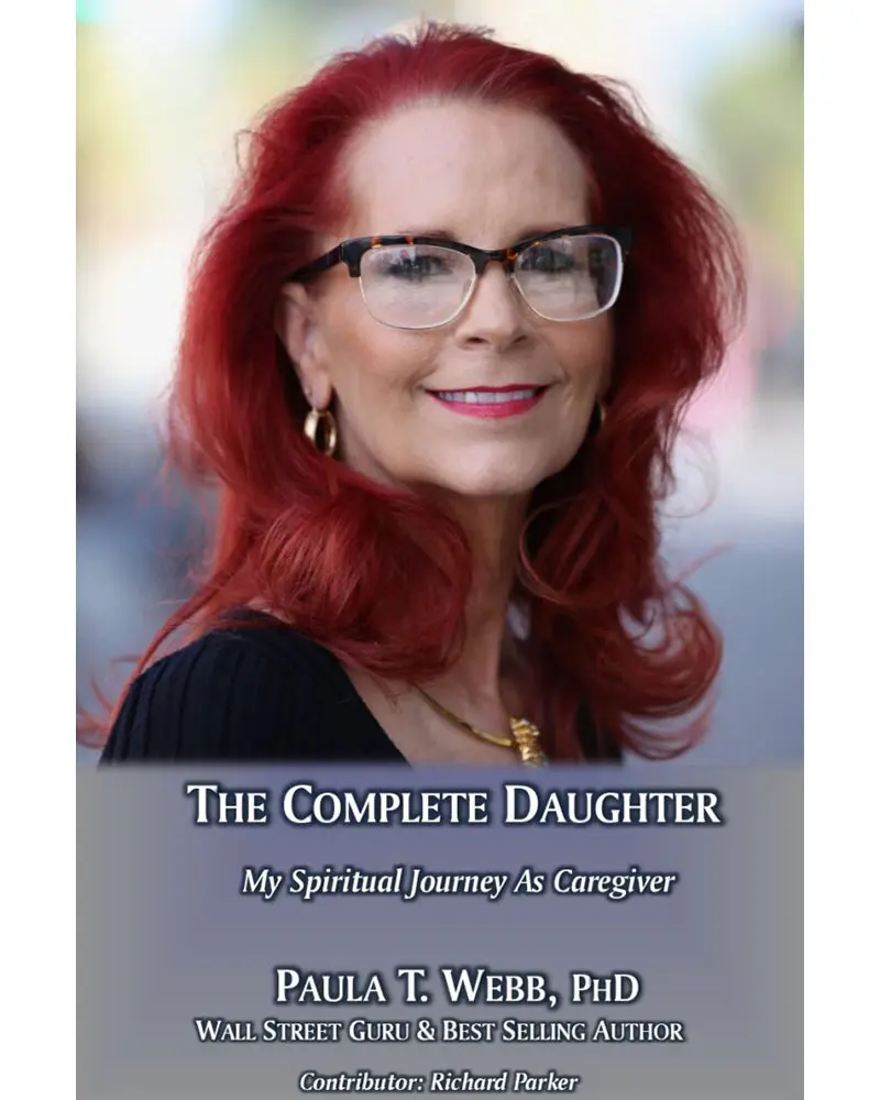 A woman with red hair and glasses is smiling.