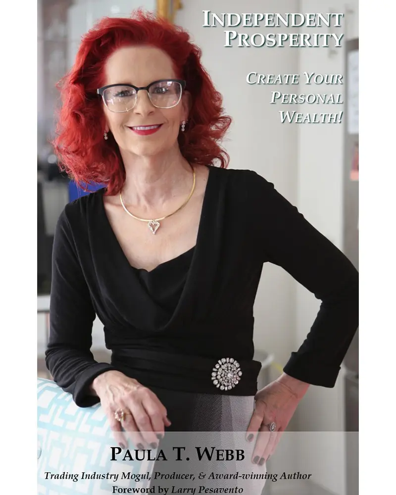 A woman with red hair and glasses is wearing black.